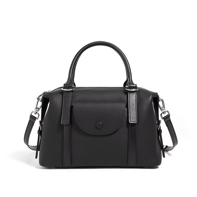 Black handbag with a strap on a white background