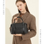 Woman holding a black handbag against a beige background with 'Famicare' branding.