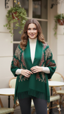 Woman wearing a green patterned shawl in an outdoor cafe setting