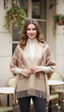 Woman wearing a beige floral-patterned shawl outdoors.